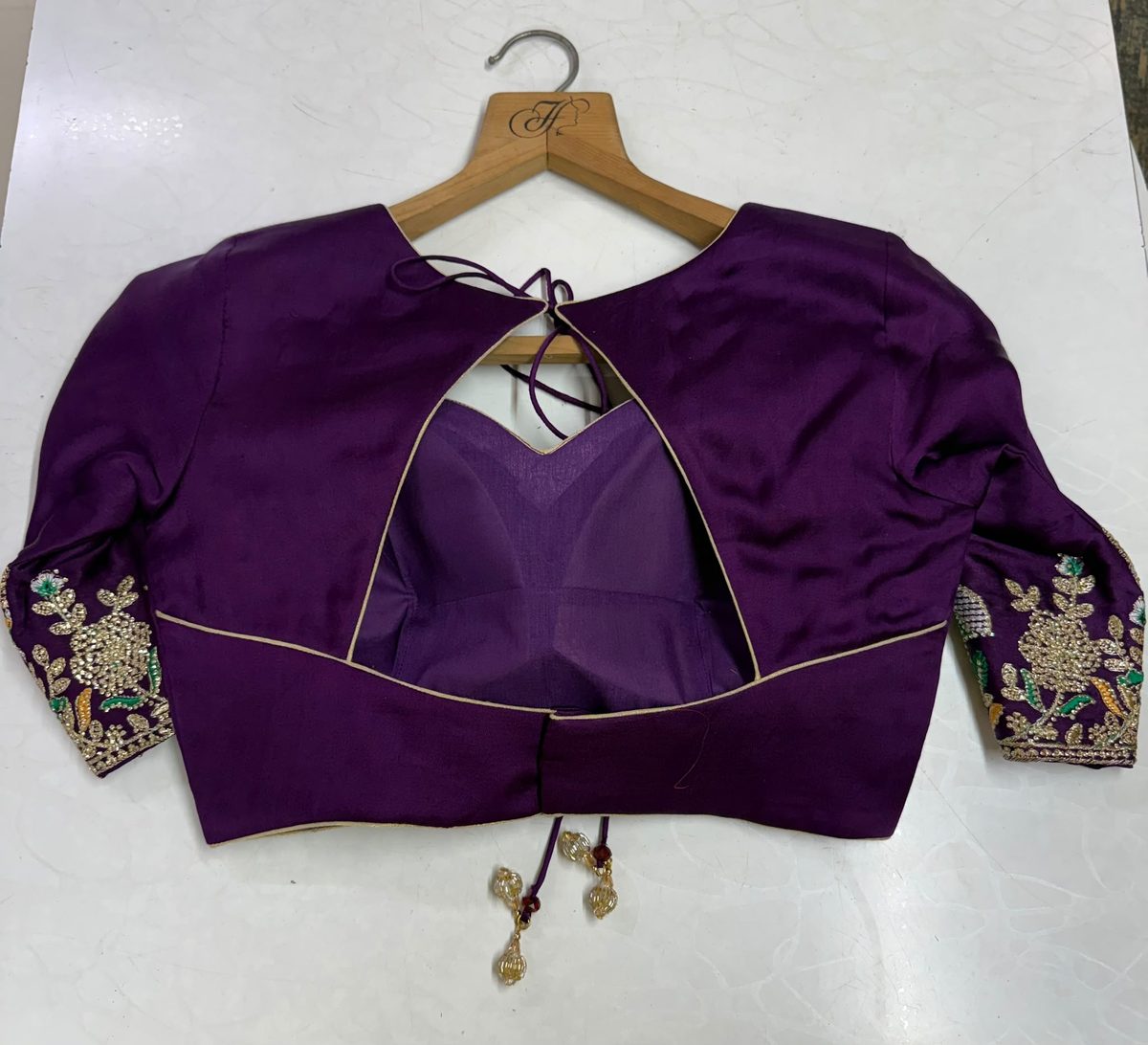Keyhole back design — hand-finished purple blouse with golden bead tassels by Hingu Fashion Designer